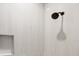 Shower featuring tiled walls, a showerhead, and built-in shelving at 10443 Riverside Rd, Port Charlotte, FL 33981