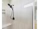 Walk-in shower with tile surround, shower head, and built-in niche at 10443 Riverside Rd, Port Charlotte, FL 33981