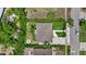 Aerial view of a property with a well-maintained lawn, patio area, fire pit, and charming house at 1051 Indian Beach Dr, Sarasota, FL 34234