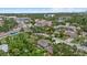 Stunning aerial view of a neighborhood in Sarasota, Florida, with lush trees and clear blue skies at 1051 Indian Beach Dr, Sarasota, FL 34234