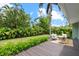 Outdoor space featuring a dark wood patio with comfortable seating arrangements, surrounded by beautiful green foliage and trees at 1051 Indian Beach Dr, Sarasota, FL 34234