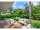 Inviting back patio with comfortable seating, perfect for outdoor relaxation amidst lush landscaping and a fire pit area at 1051 Indian Beach Dr, Sarasota, FL 34234