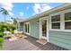 Back porch featuring an outdoor seating area with a view of the property's lush landscaping at 1051 Indian Beach Dr, Sarasota, FL 34234