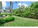 Lush backyard showcasing a patio, seating area around a fire pit, and beautiful tropical landscaping for outdoor enjoyment at 1051 Indian Beach Dr, Sarasota, FL 34234