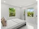 Bright bedroom with two windows that bring in natural light and a full-length mirror at 1051 Indian Beach Dr, Sarasota, FL 34234