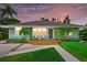 Lovely single-story home with a inviting front porch with chairs, perfect for enjoying the outdoors at 1051 Indian Beach Dr, Sarasota, FL 34234