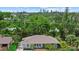Charming single-story home with inviting front porch, beautiful landscaping, and a well-manicured lawn at 1051 Indian Beach Dr, Sarasota, FL 34234