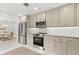 Modern kitchen with stainless steel appliances, sleek countertops, and an open layout connected to the dining area at 1051 Indian Beach Dr, Sarasota, FL 34234