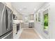 Well-lit kitchen features stainless steel appliances, bright cabinets, and a convenient door to the backyard at 1051 Indian Beach Dr, Sarasota, FL 34234