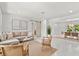 Bright living room featuring neutral decor, stylish seating, and an open layout connected to the dining area at 1051 Indian Beach Dr, Sarasota, FL 34234