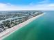 Gorgeous aerial view featuring the coastline with bright blue ocean and a white sandy beach at 107 Clipper Way # 107, Nokomis, FL 34275