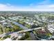 Expansive aerial shot of a residential area featuring lush greenery, canal waterways, and multiple homes at 107 Clipper Way # 107, Nokomis, FL 34275