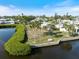 Scenic backyard on the water featuring mature trees, lush green landscaping, and patio area at 107 Clipper Way # 107, Nokomis, FL 34275