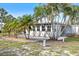 Backyard patio is framed by tropical landscaping, providing shade and privacy at 107 Clipper Way # 107, Nokomis, FL 34275