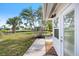 Exterior view with palm trees, a canal view, and a cozy outdoor area at 107 Clipper Way # 107, Nokomis, FL 34275