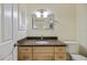 Well-lit bathroom features a vanity with light wood cabinets and a stylish countertop at 107 Clipper Way # 107, Nokomis, FL 34275