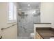 A modern bathroom featuring a glass-enclosed marble tiled shower at 107 Clipper Way # 107, Nokomis, FL 34275