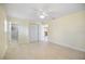 Bright, neutral bedroom with tile floors, access to bathroom, and large closet at 107 Clipper Way # 107, Nokomis, FL 34275