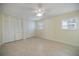 Neutral bedroom featuring tile floors, plantation shutters and a double-door closet at 107 Clipper Way # 107, Nokomis, FL 34275