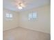Empty bedroom featuring tile floors and plantation shutters at 107 Clipper Way # 107, Nokomis, FL 34275