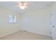 Light-filled bedroom with tile floors, ceiling fan, and a double closet at 107 Clipper Way # 107, Nokomis, FL 34275
