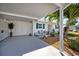 Charming exterior with a covered parking area, complemented by a lush tropical landscape at 107 Clipper Way # 107, Nokomis, FL 34275