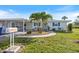 Charming single-story home with a well-manicured lawn, complemented by vibrant blue shutters and a convenient carport at 107 Clipper Way # 107, Nokomis, FL 34275