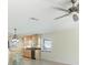 Open-concept kitchen featuring wooden cabinets, granite countertops, stainless steel appliances, and an adjacent dining area at 107 Clipper Way # 107, Nokomis, FL 34275