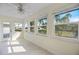 Sunroom with tile flooring, multiple windows providing natural light and views of the lush outdoor landscape at 107 Clipper Way # 107, Nokomis, FL 34275