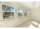 Bright sun room with large windows and a view of the landscaped yard at 107 Clipper Way # 107, Nokomis, FL 34275