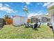 Spacious backyard featuring a fire pit with chairs, perfect for outdoor gatherings, plus a storage shed at 111 66Th Street E Ct, Bradenton, FL 34208