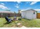 Private backyard space featuring a charming fire pit, chairs and storage shed, perfect for outdoor relaxation at 111 66Th Street E Ct, Bradenton, FL 34208
