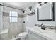 Bathroom with updated fixtures, tiled shower, and vanity at 111 66Th Street E Ct, Bradenton, FL 34208