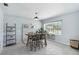 Bright dining space featuring a window bench, modern shelving, and a charming brick accent wall at 111 66Th Street E Ct, Bradenton, FL 34208