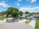 Charming home featuring lush landscaping, a large shade tree, and convenient driveway parking for multiple vehicles at 111 66Th Street E Ct, Bradenton, FL 34208