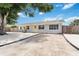 Charming single-story home with a well-maintained yard, a yellow front door, and a welcoming curb appeal at 111 66Th Street E Ct, Bradenton, FL 34208