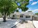 Charming single-story home with a well-maintained yard, a yellow front door, and a welcoming curb appeal at 111 66Th Street E Ct, Bradenton, FL 34208