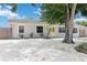 Charming single-story home with a bright yellow door and white rock landscaping at 111 66Th Street E Ct, Bradenton, FL 34208