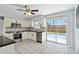 Updated kitchen with stainless steel appliances and a view of the pool through sliding glass doors at 111 66Th Street E Ct, Bradenton, FL 34208