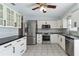 Modern kitchen with stainless steel appliances, white cabinets, and tiled backsplash at 111 66Th Street E Ct, Bradenton, FL 34208
