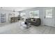 Bright living room featuring tile flooring, a comfortable sofa, and modern décor with plenty of natural light at 111 66Th Street E Ct, Bradenton, FL 34208
