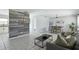 Spacious living area with modern decor, tile floors, wood accent wall, and seamless transition to kitchen at 111 66Th Street E Ct, Bradenton, FL 34208