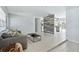 Open-concept living area with a kitchen view, tile floors, and a gray wood accent wall for modern living at 111 66Th Street E Ct, Bradenton, FL 34208