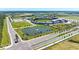 Aerial view showcasing a baseball stadium with manicured landscaping, surrounding streets, and community amenities at 11327 Burgundy Dr, Venice, FL 34293