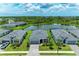 An aerial view of the home's tile roof and backyard pond at 11327 Burgundy Dr, Venice, FL 34293