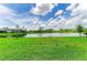 Lush green lawn and lake in the backyard at 11327 Burgundy Dr, Venice, FL 34293