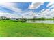 Expansive green lawn leads to a tranquil lake at 11327 Burgundy Dr, Venice, FL 34293