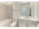 Bathroom with tiled shower and tub combination, and vanity with white cabinets at 11327 Burgundy Dr, Venice, FL 34293