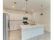 A modern kitchen is equipped with stainless steel appliances and a large island at 11327 Burgundy Dr, Venice, FL 34293