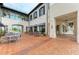 Outdoor patio area with cozy seating arrangements, shaded by awnings and surrounded by well-maintained landscaping at 11327 Burgundy Dr, Venice, FL 34293